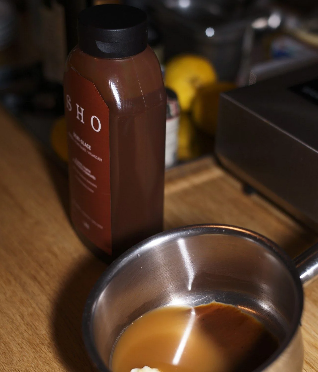 SHO Demi-Glace bottle next to a small pot on a wooden counter, how to store guidance