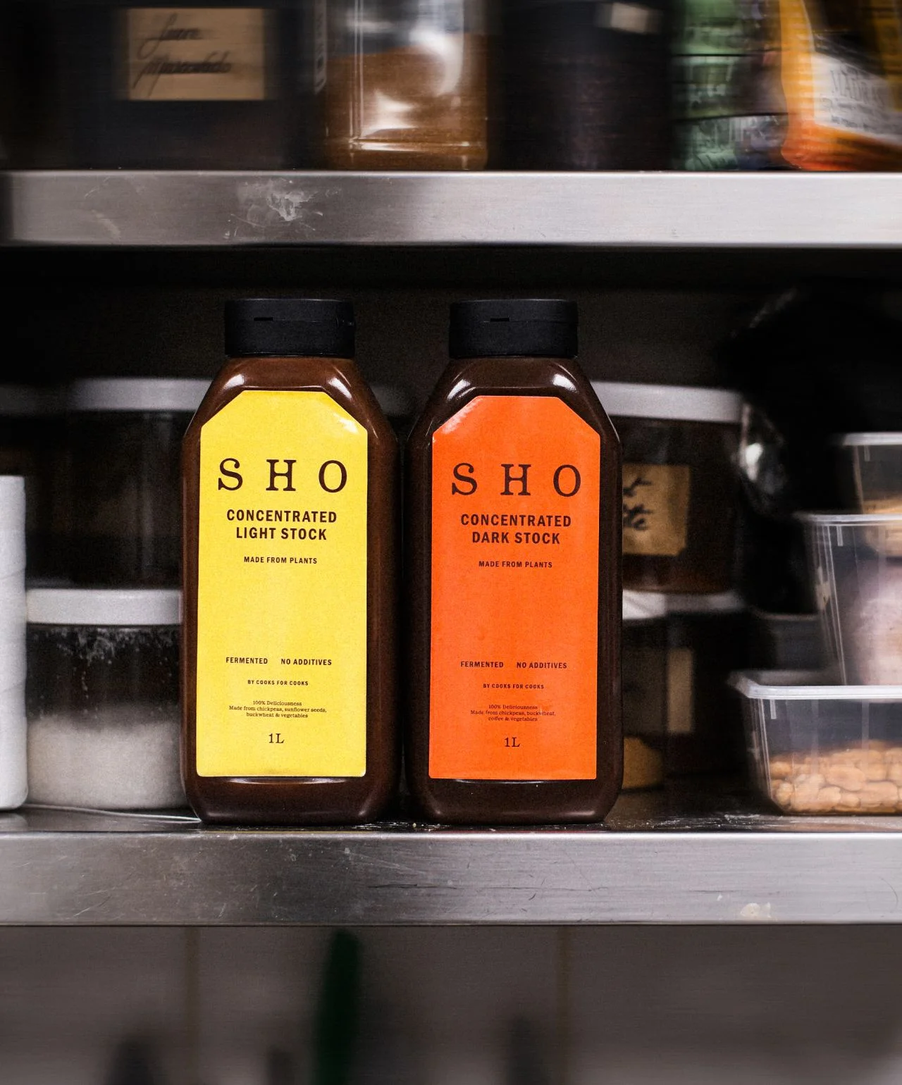 SHO Concentrated Light Stock and Dark Stock bottles on a kitchen shelf, EATTT's culinary bases page