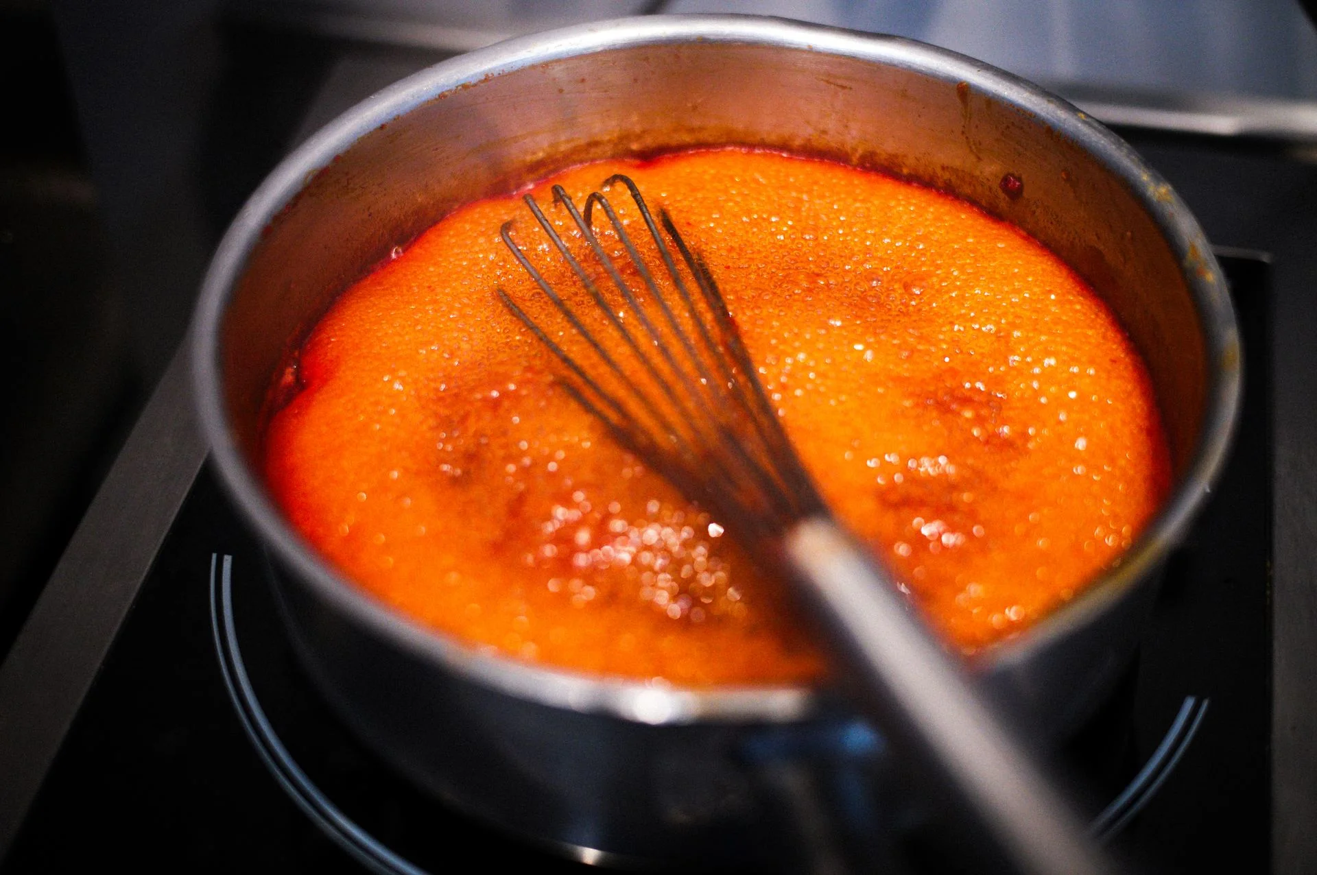 Gros plan d'une sauce mijotée fouettée dans une casserole, bannière de la page Pourquoi nous cuisinons